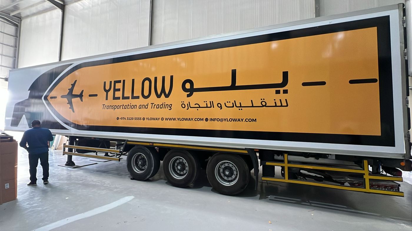 Yellow trailer livery in a workshop