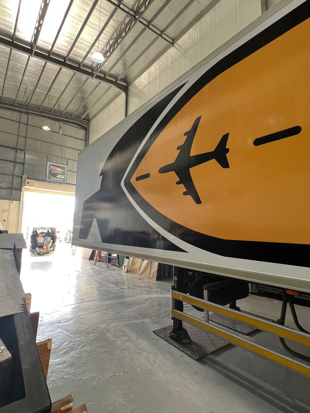 Close-up of the Yellow trailer graphic with the plane and route